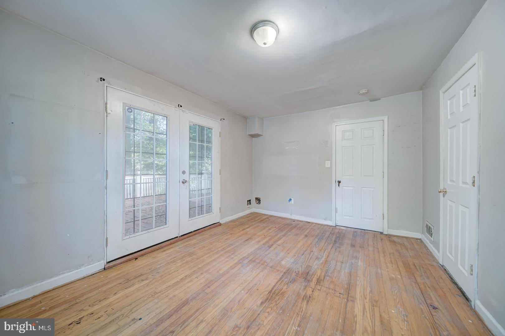 802 Modoc Lane Oxon Hill, MD 20745 - Photo 24 of 34 wooden floor in an empty room with a window