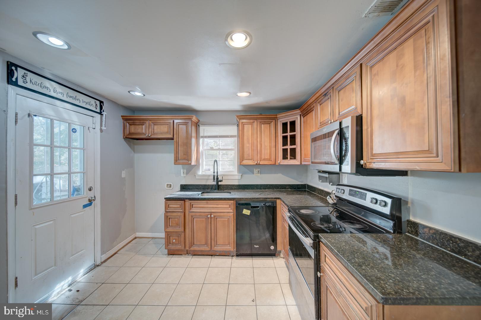802 Modoc Lane Oxon Hill, MD 20745 - Photo 27 of 34 a kitchen with stainless steel appliances granite countertop a stove sink and cabinets