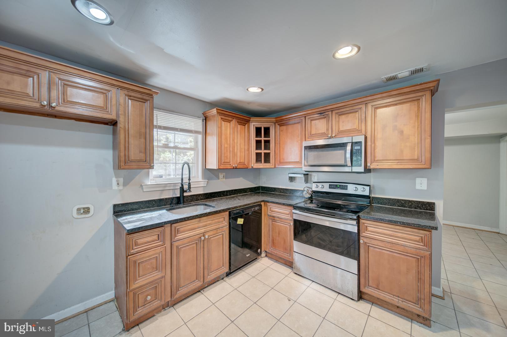 802 Modoc Lane Oxon Hill, MD 20745 - Photo 28 of 34 a kitchen with stainless steel appliances granite countertop a stove sink and cabinets