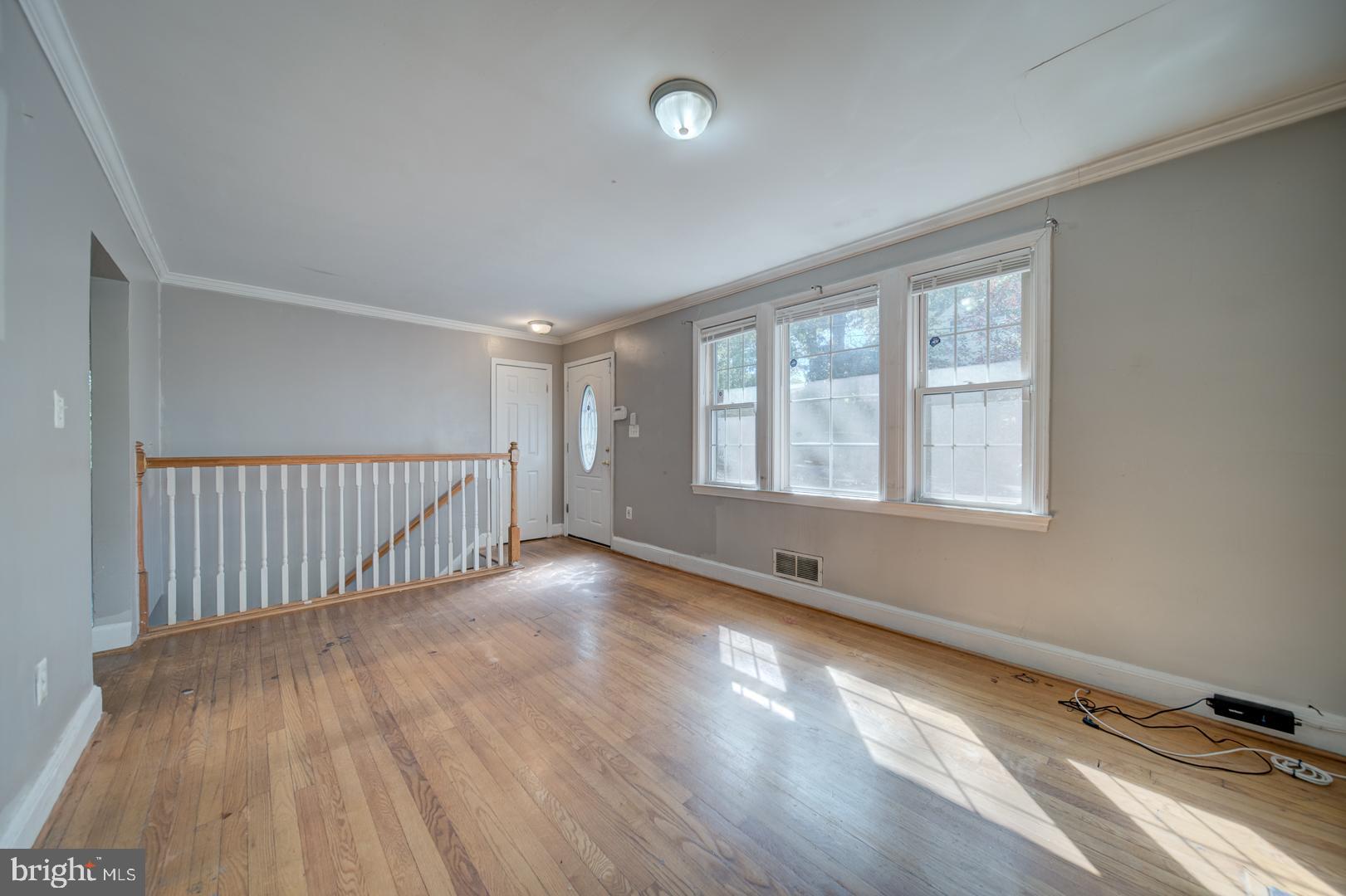 802 Modoc Lane Oxon Hill, MD 20745 - Photo 8 of 34 wooden floor in an empty room with a window