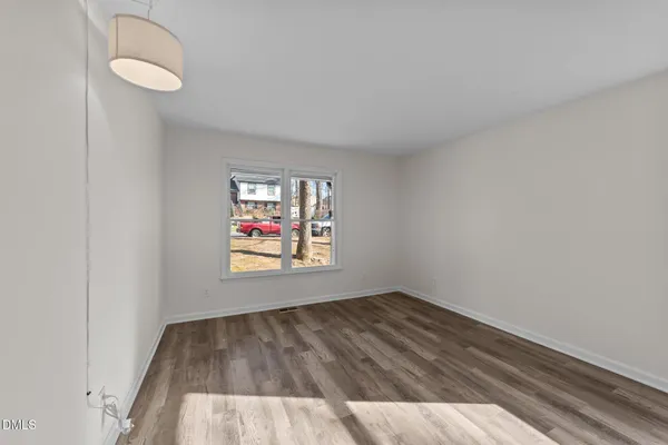 wooden floor in an empty room with a window