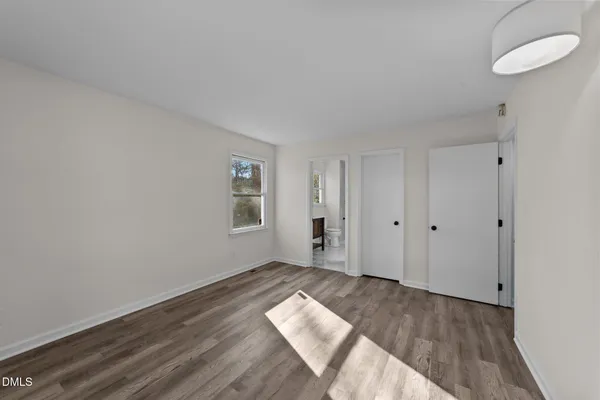 a view of wooden floor and windows in a room