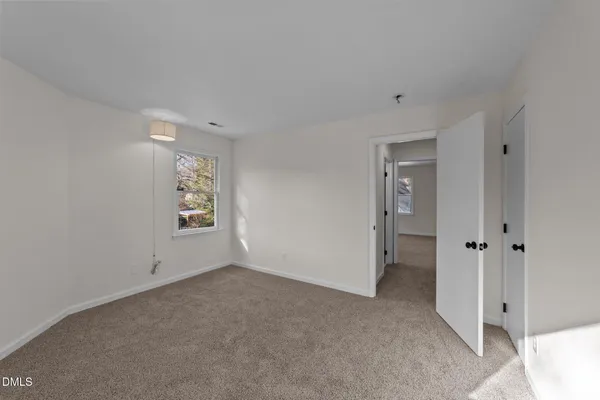 an empty room with windows and closet