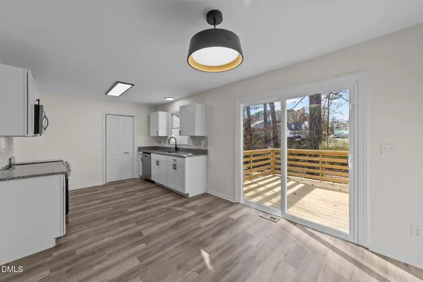 a kitchen with a refrigerator and a sink