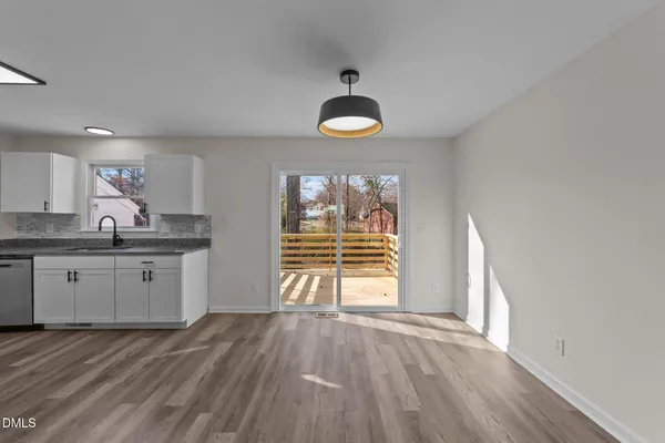 a kitchen with stainless steel appliances granite countertop a stove a sink and a large window