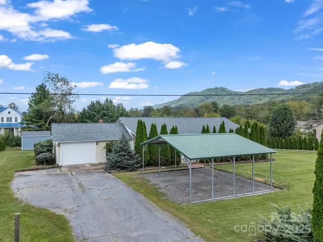 a view of a patio with table and chairs under an umbrella