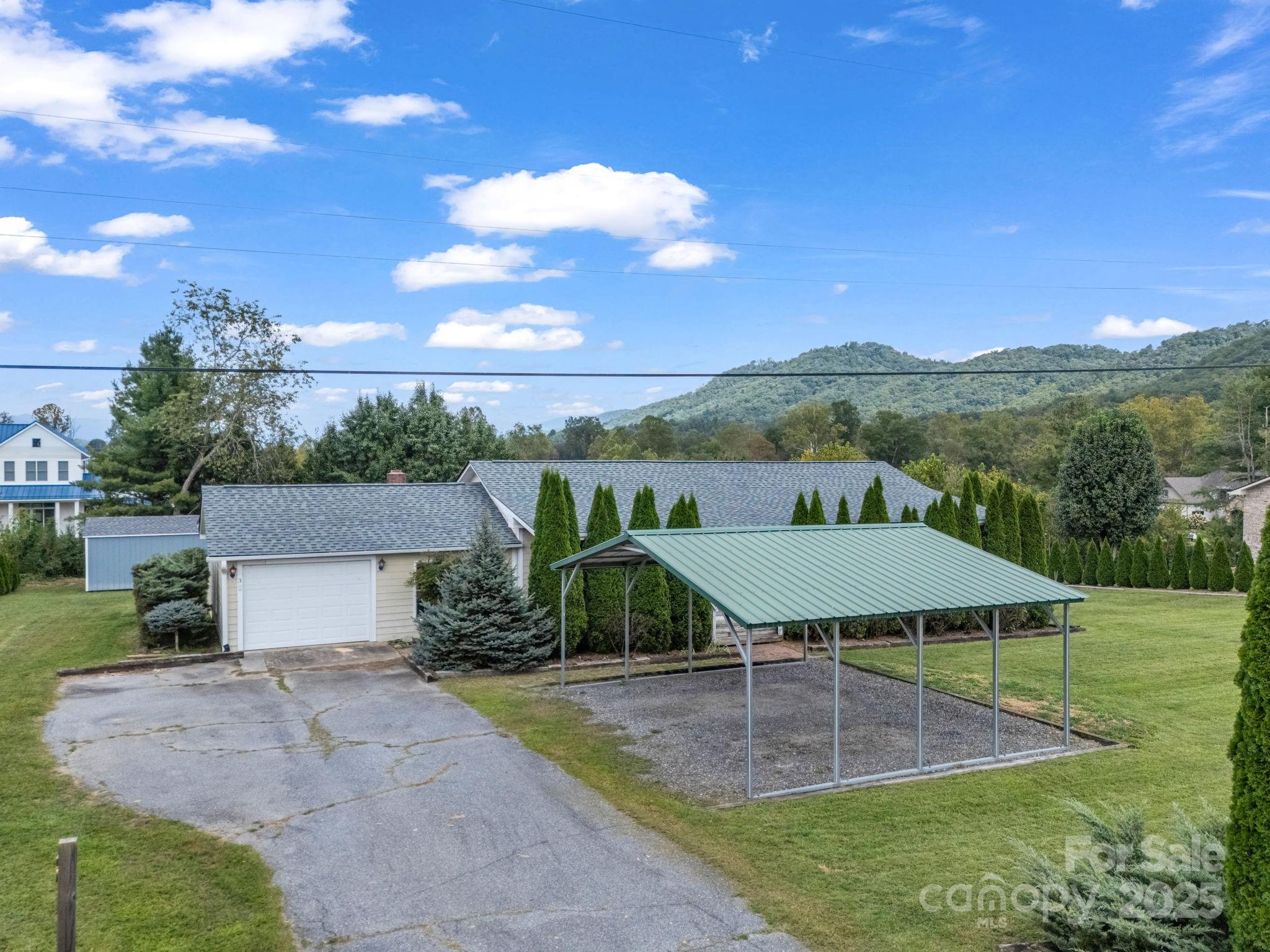 a view of a patio with table and chairs under an umbrella
