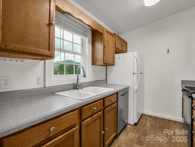 a kitchen with a sink a refrigerator and window