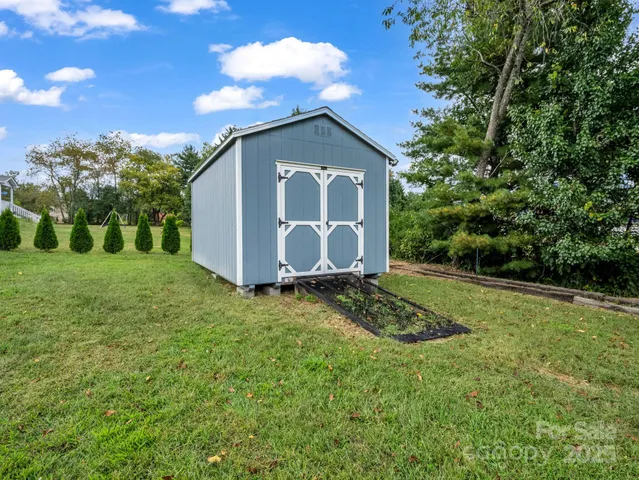 a view of a house with a yard and sitting area