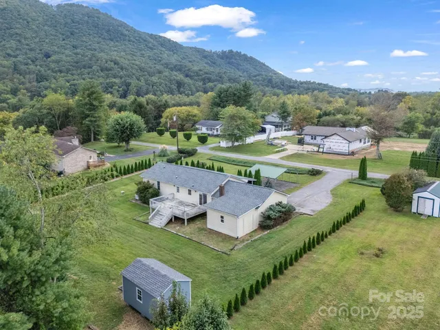 an aerial view of a house with a lake view