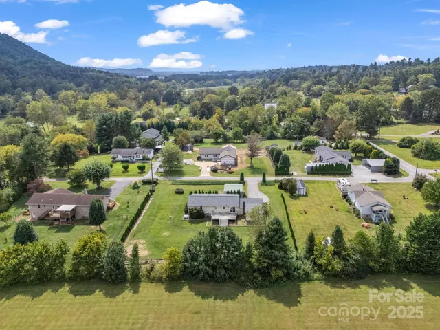 an aerial view of lake residential houses with outdoor space and lake view