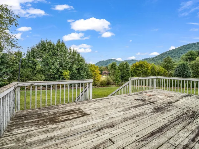 a view of balcony with wooden floor and fence