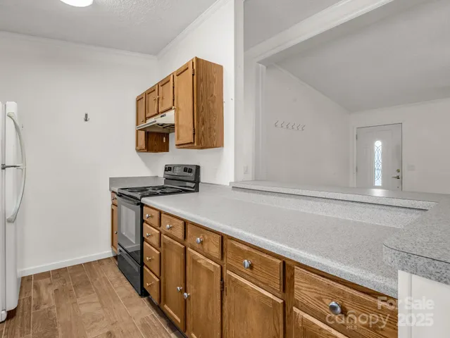 a kitchen with stainless steel appliances granite countertop a sink stove and microwave