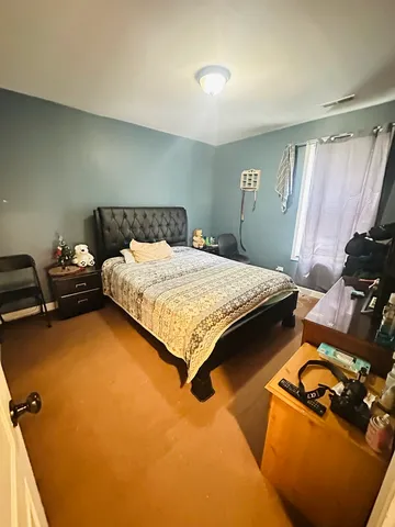 a bed sitting in a room next to a window