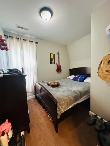 a bedroom with a bed and a dresser