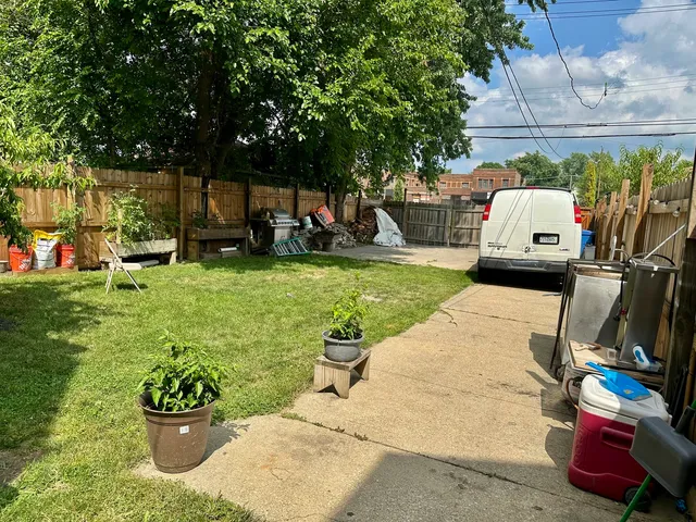 a view of a backyard with sitting area