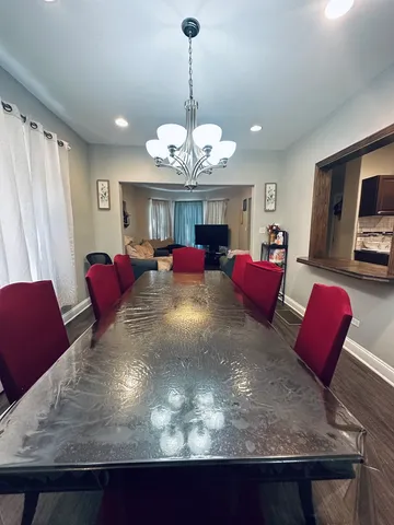 a living room with furniture chandelier and flat screen tv