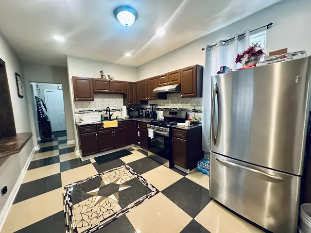 a kitchen with stainless steel appliances granite countertop a refrigerator oven a sink and dishwasher