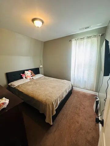 a bedroom with a bed and a dresser