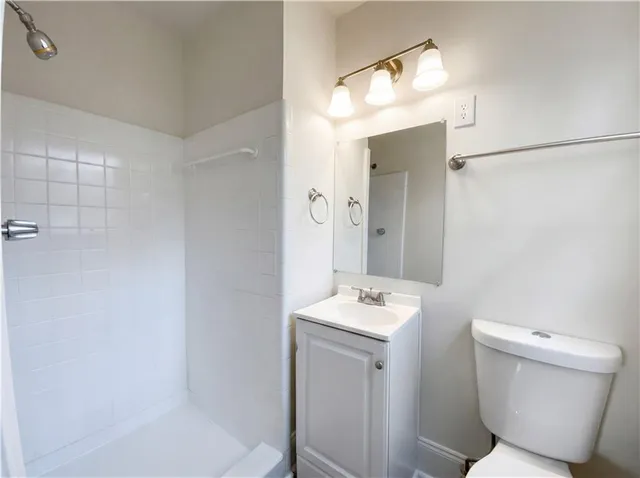 a bathroom with a sink a toilet and mirror