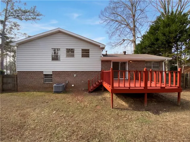 a view of a house with a yard balcony and sitting area