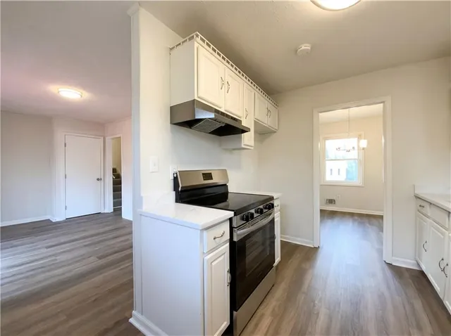 a kitchen with stainless steel appliances a stove a sink and a refrigerator