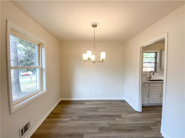 a view of a livingroom with wooden floor windows and entryway