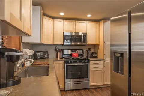 a kitchen with stainless steel appliances granite countertop a stove and a refrigerator