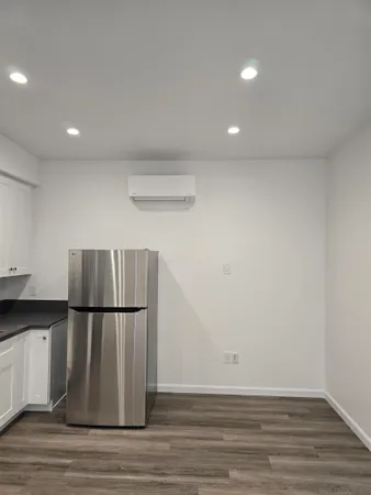 a view of a refrigerator in kitchen and wooden floor
