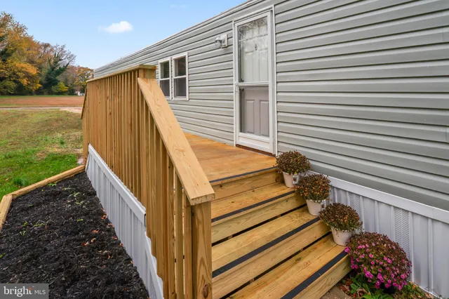 a view of a balcony with door and wooden floor