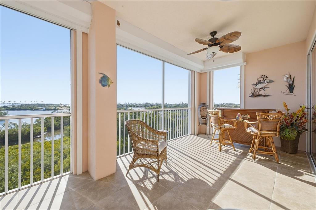 13113 Gasparilla Road, Unit 403 Placida, FL 33946 - Photo 36 of 62 a bedroom with furniture and large windows