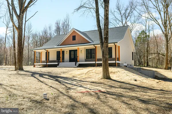 a view of a house with snow on the road