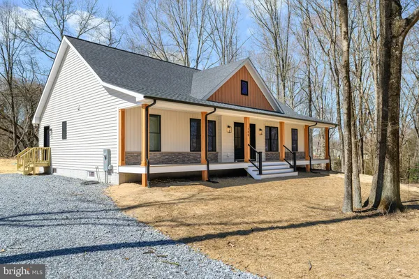 a view of a house with backyard porch and sitting area