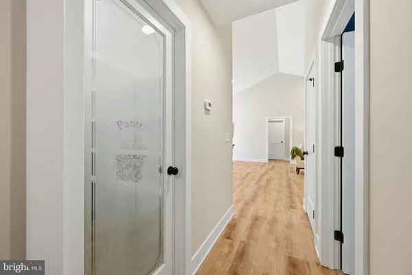 a kitchen with a table chairs refrigerator and cabinets