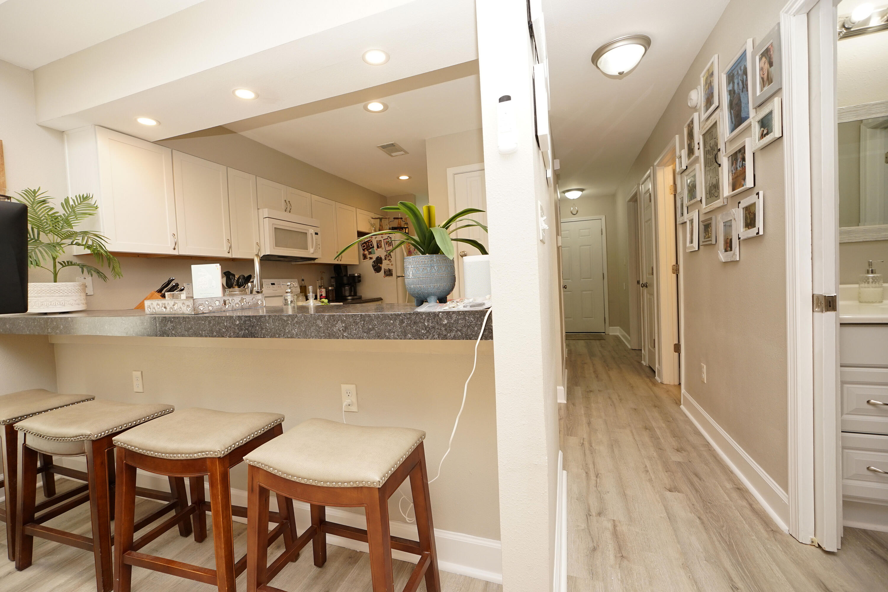 1503 Green Acres Boulevard, Unit E Fort Walton Beach, FL 32547 - Photo 11 of 25 a kitchen with stainless steel appliances granite countertop a table chairs and a refrigerator