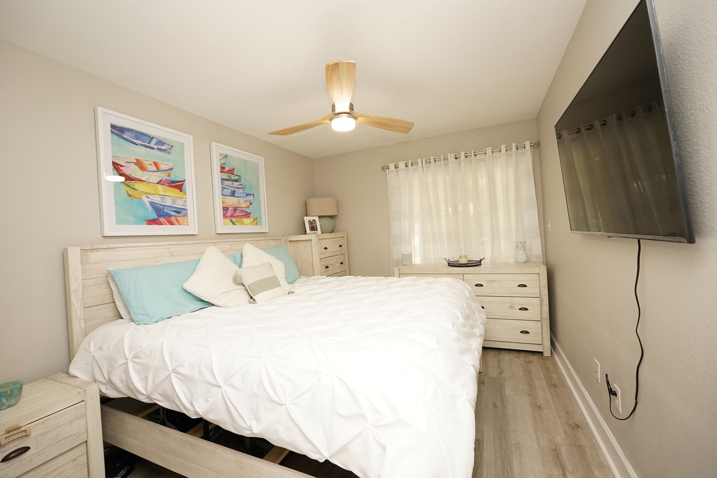 1503 Green Acres Boulevard, Unit E Fort Walton Beach, FL 32547 - Photo 16 of 25 a bedroom with a bed and a chandelier