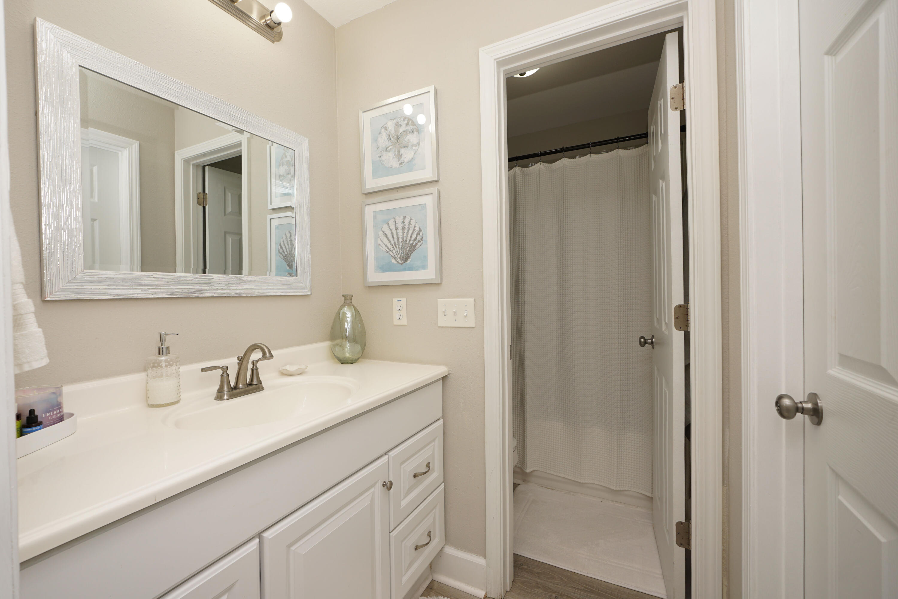 1503 Green Acres Boulevard, Unit E Fort Walton Beach, FL 32547 - Photo 17 of 25 a bathroom with a sink and mirror
