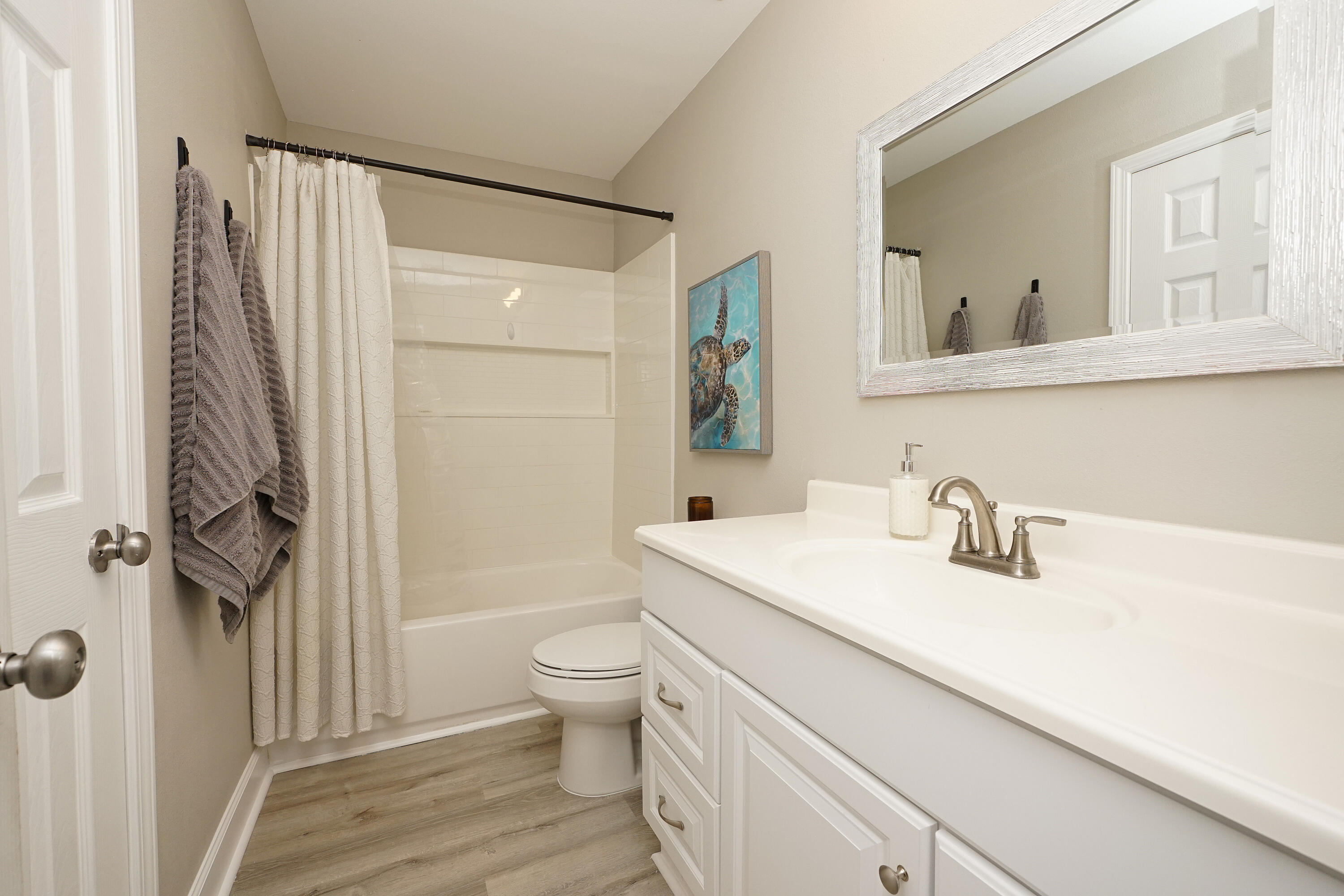 1503 Green Acres Boulevard, Unit E Fort Walton Beach, FL 32547 - Photo 19 of 25 a bathroom with a sink toilet and shower
