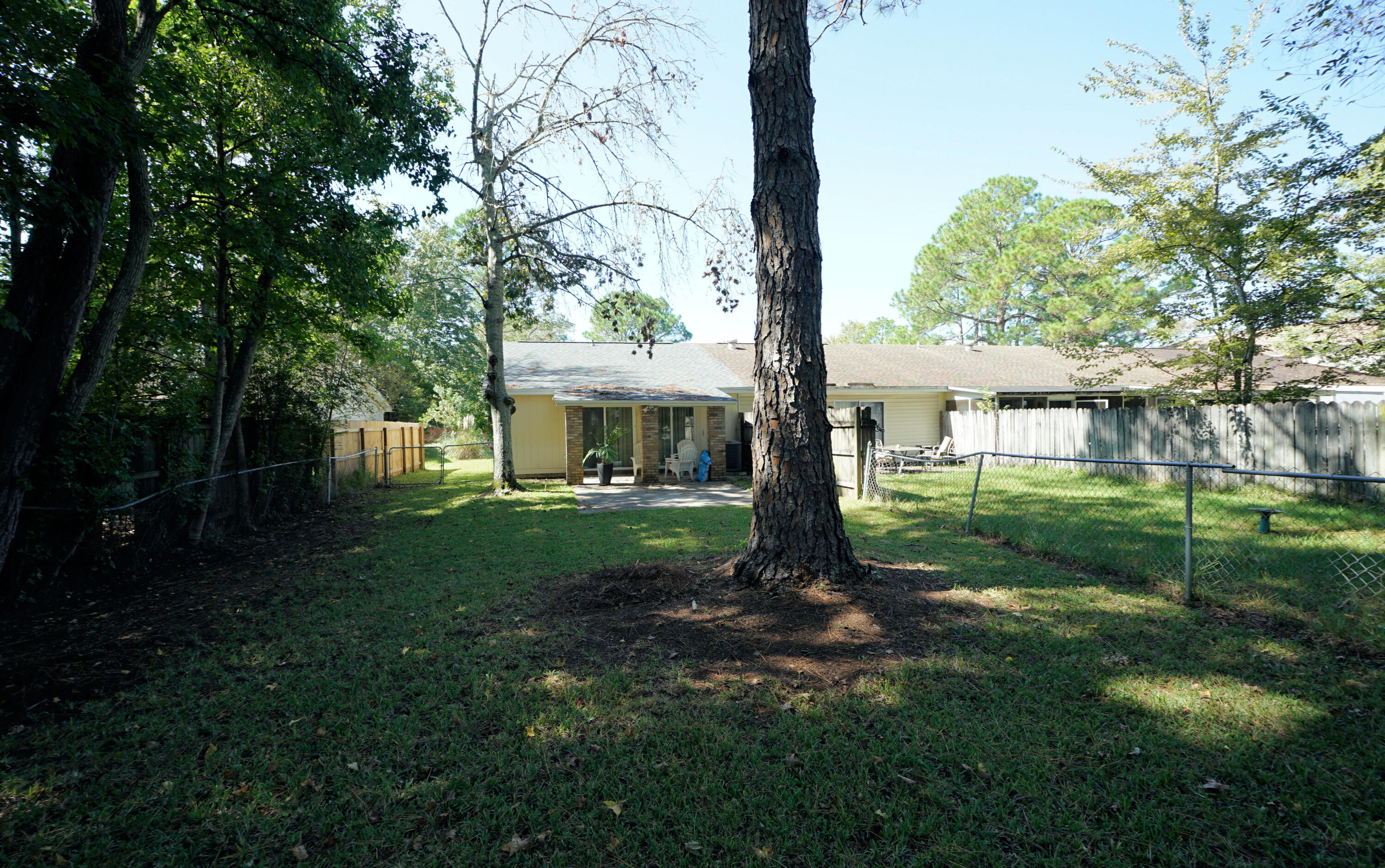 1503 Green Acres Boulevard, Unit E Fort Walton Beach, FL 32547 - Photo 24 of 25 a view of a house with backyard and a tree