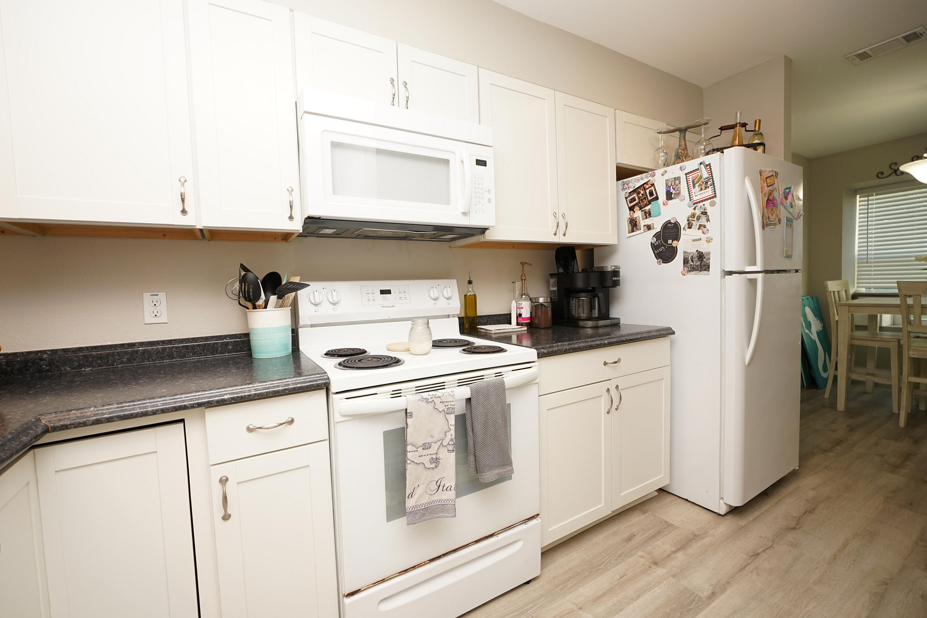 1503 Green Acres Boulevard, Unit E Fort Walton Beach, FL 32547 - Photo 10 of 25 a kitchen with granite countertop white cabinets and white appliances