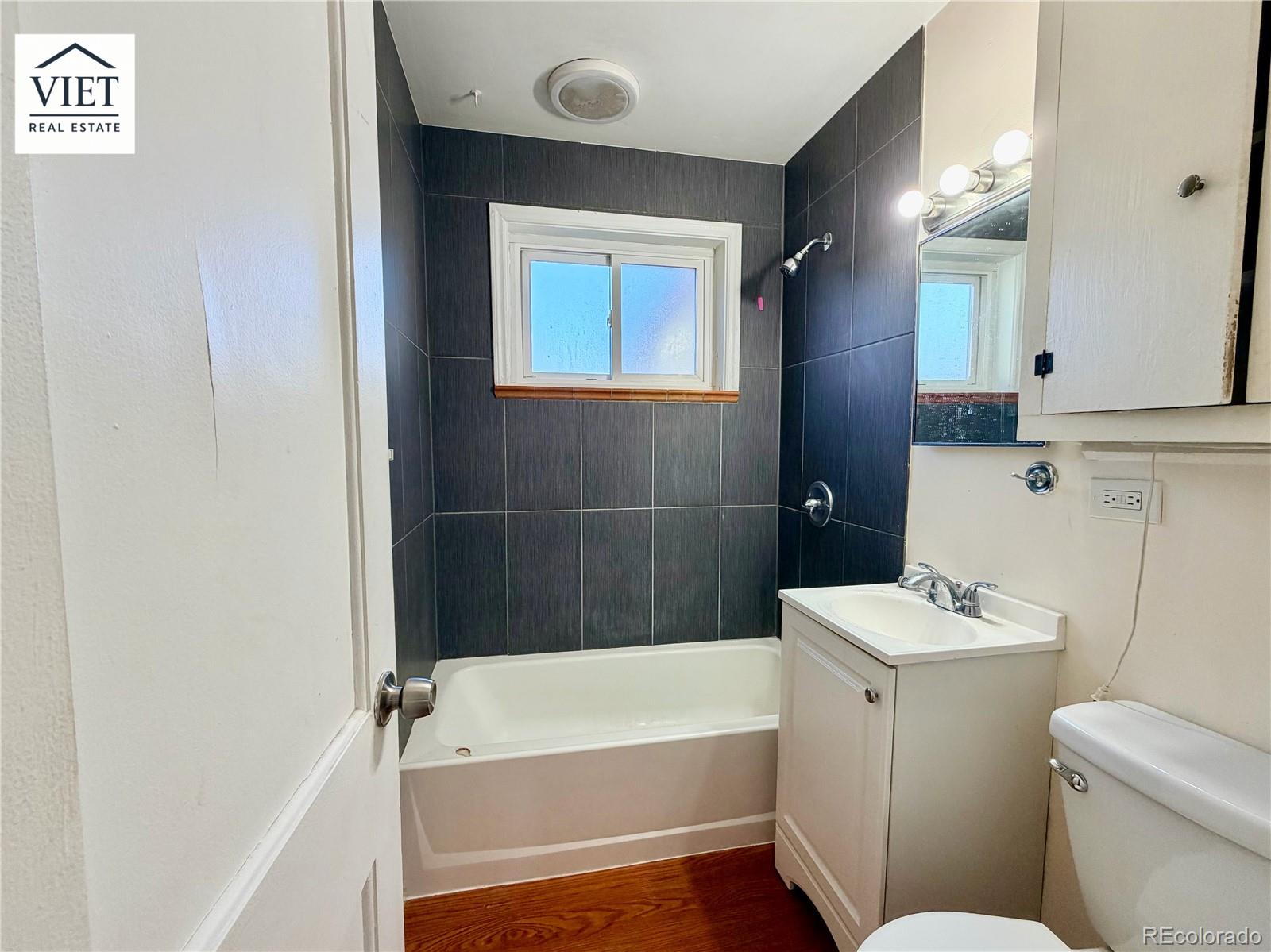 1055 Leyden Street Denver, CO 80220 - Photo 4 of 5 a bathroom with a sink a toilet and bathtub