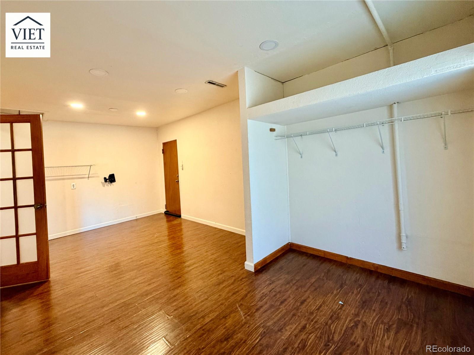 1055 Leyden Street Denver, CO 80220 - Photo 5 of 5 a view of an empty room with wooden floor