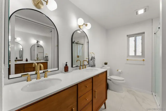 a bathroom with a double vanity sink and a mirror
