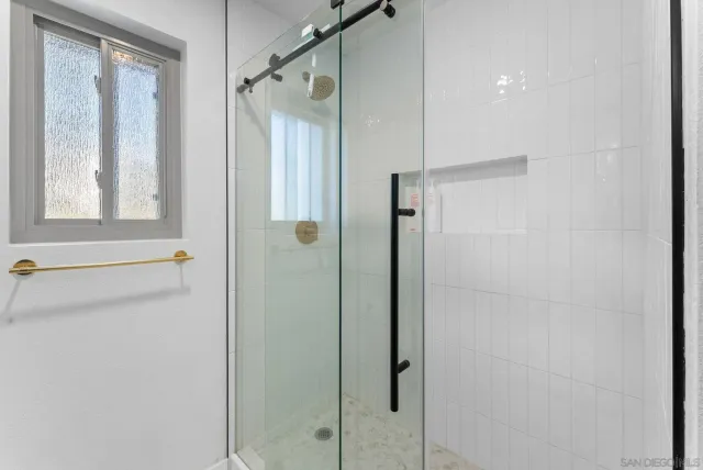 a bathroom with a shower and a window