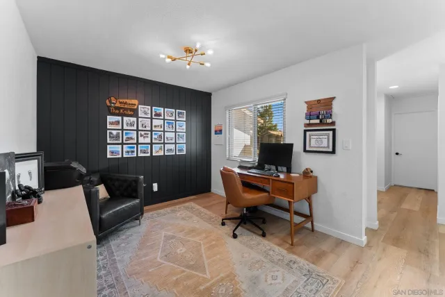 a living room with furniture and a piano