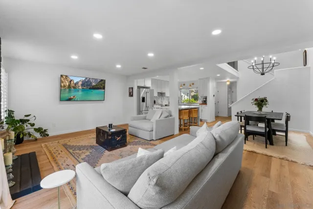 a living room with furniture kitchen and a table