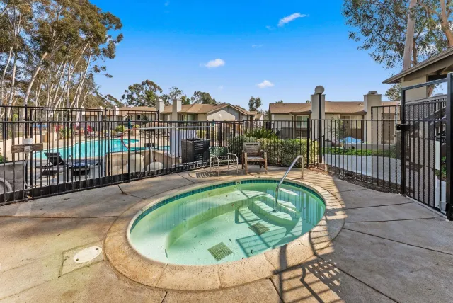 a swimming pool with outdoor seating and city view