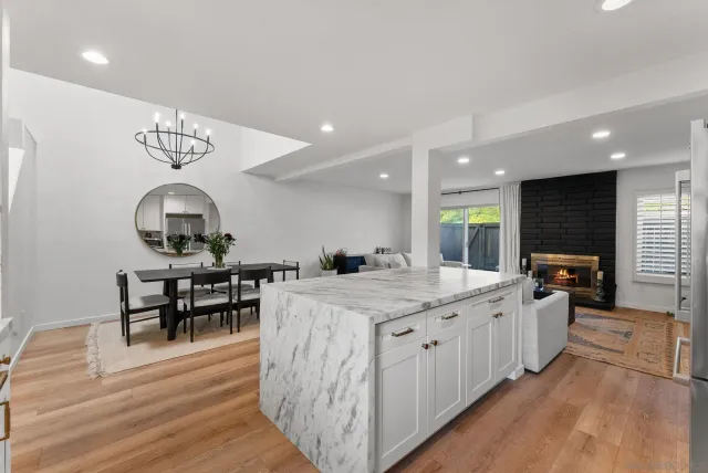 a kitchen with a sink stove and wooden floor