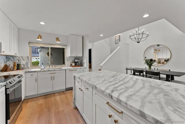 a kitchen with a sink a stove and cabinets