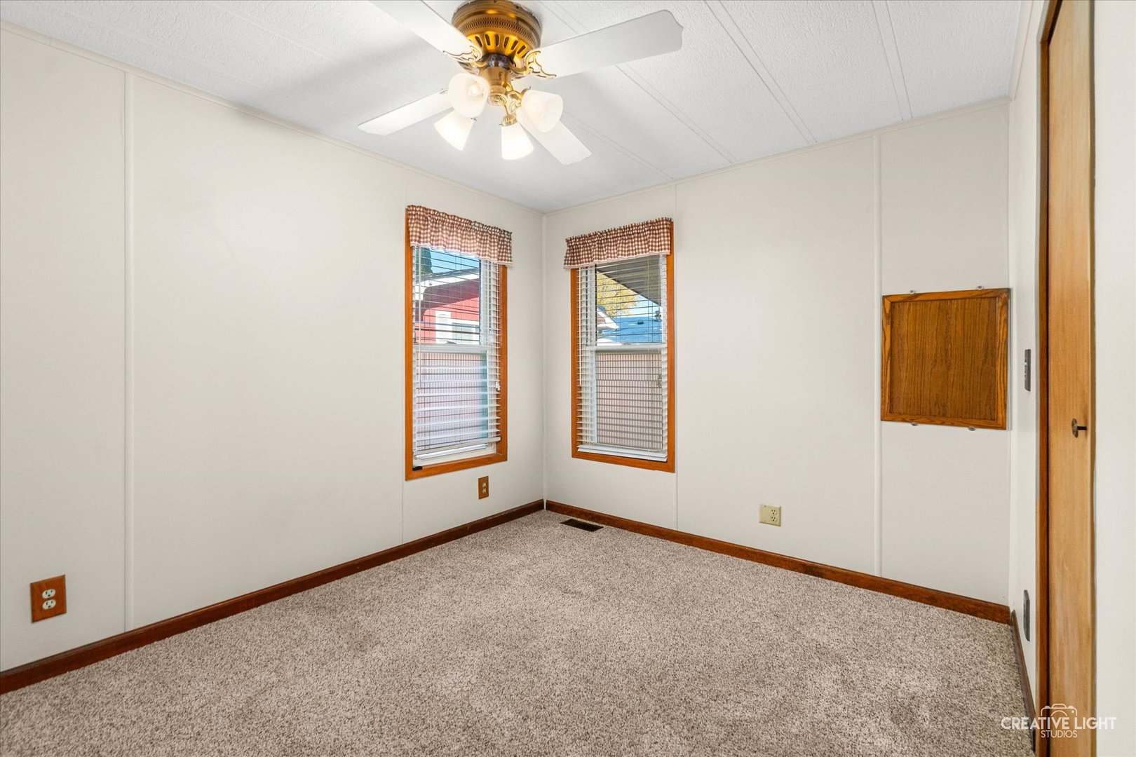 1122 Candida Road Elgin, IL 60123 - Photo 12 of 16 an empty room with windows and fan